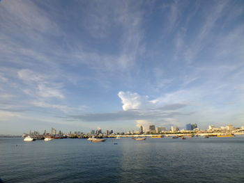 Scenic view of sea by buildings against sky