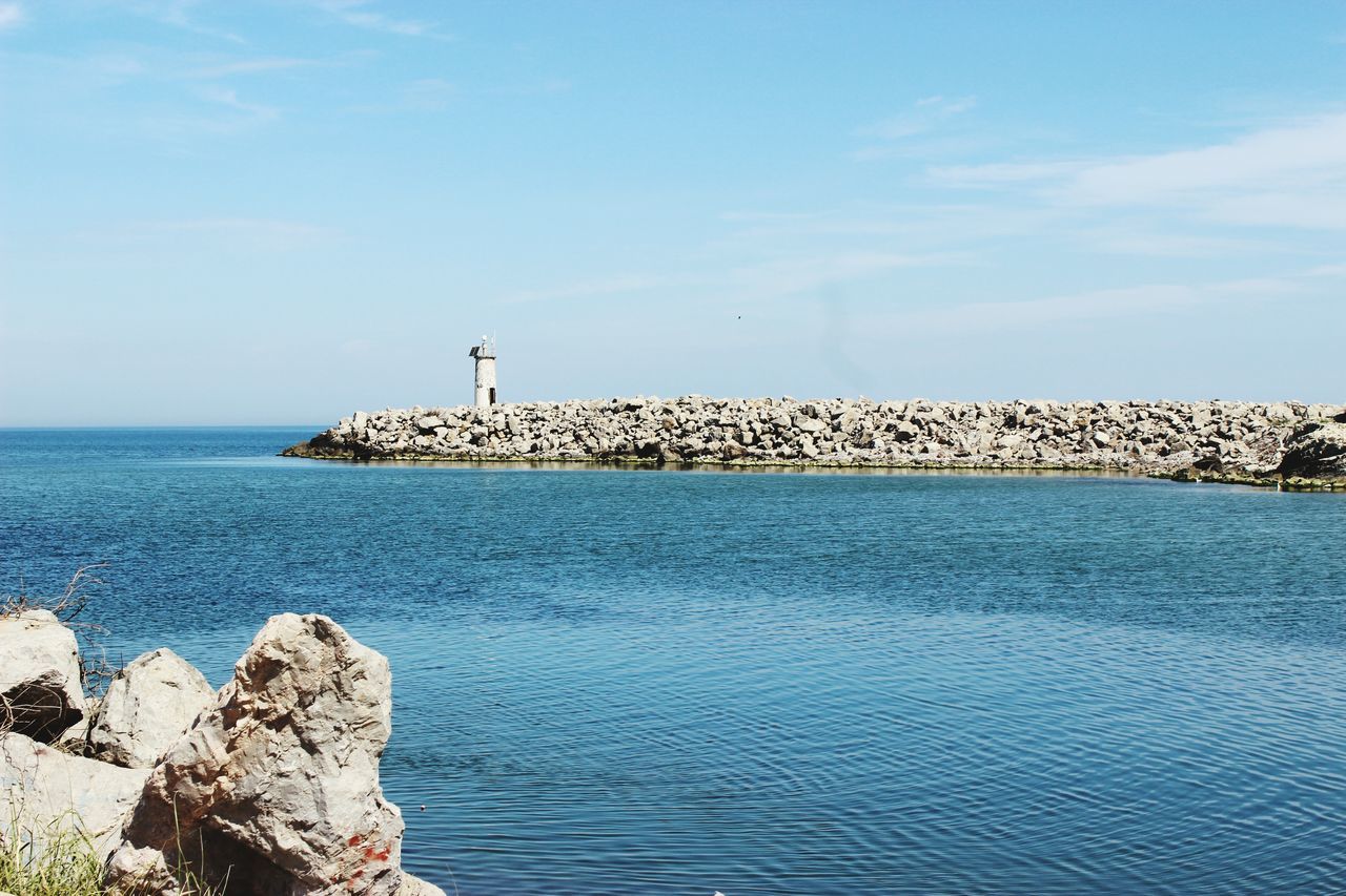 sea, water, horizon over water, built structure, sky, blue, rippled, architecture, tranquility, tranquil scene, scenics, waterfront, nature, building exterior, beauty in nature, lighthouse, ocean, idyllic, pier, day