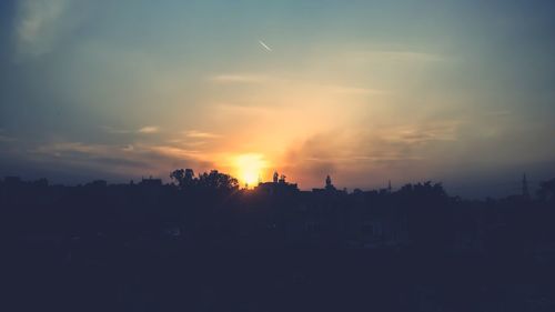 Silhouette trees against sky during sunset