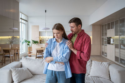 Portrait of smiling couple standing at home