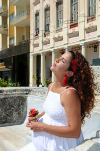 Side view of woman in front of building