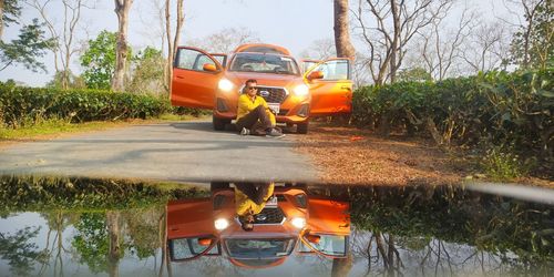 Vintage car on road against trees