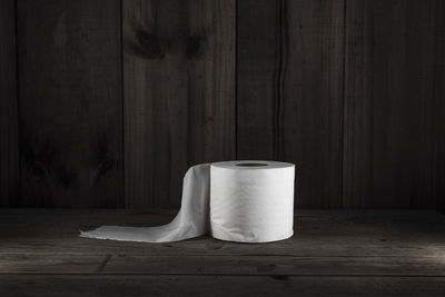 Empty table against wooden wall at home