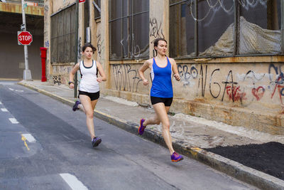 Female runners training in industrial area of brooklyn