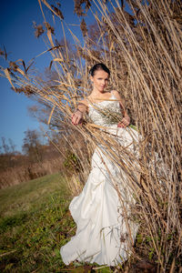 Portrait of bride standing by plants on field