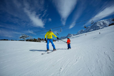 People skiing on snow covered landscape