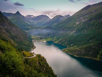 Scenic view of lake amidst mountains against sky
