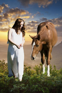 Full length of woman standing on land against sky