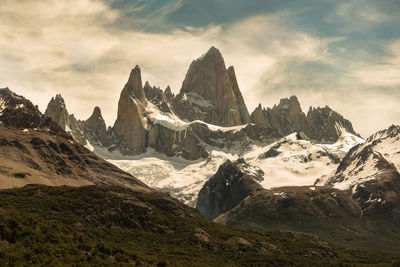 Scenic view of mountains against cloudy sky