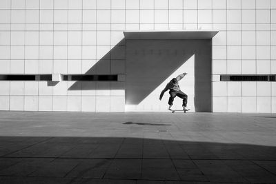 Full length of man skateboarding on wall