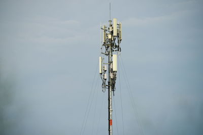 Low angle view of communications tower against sky