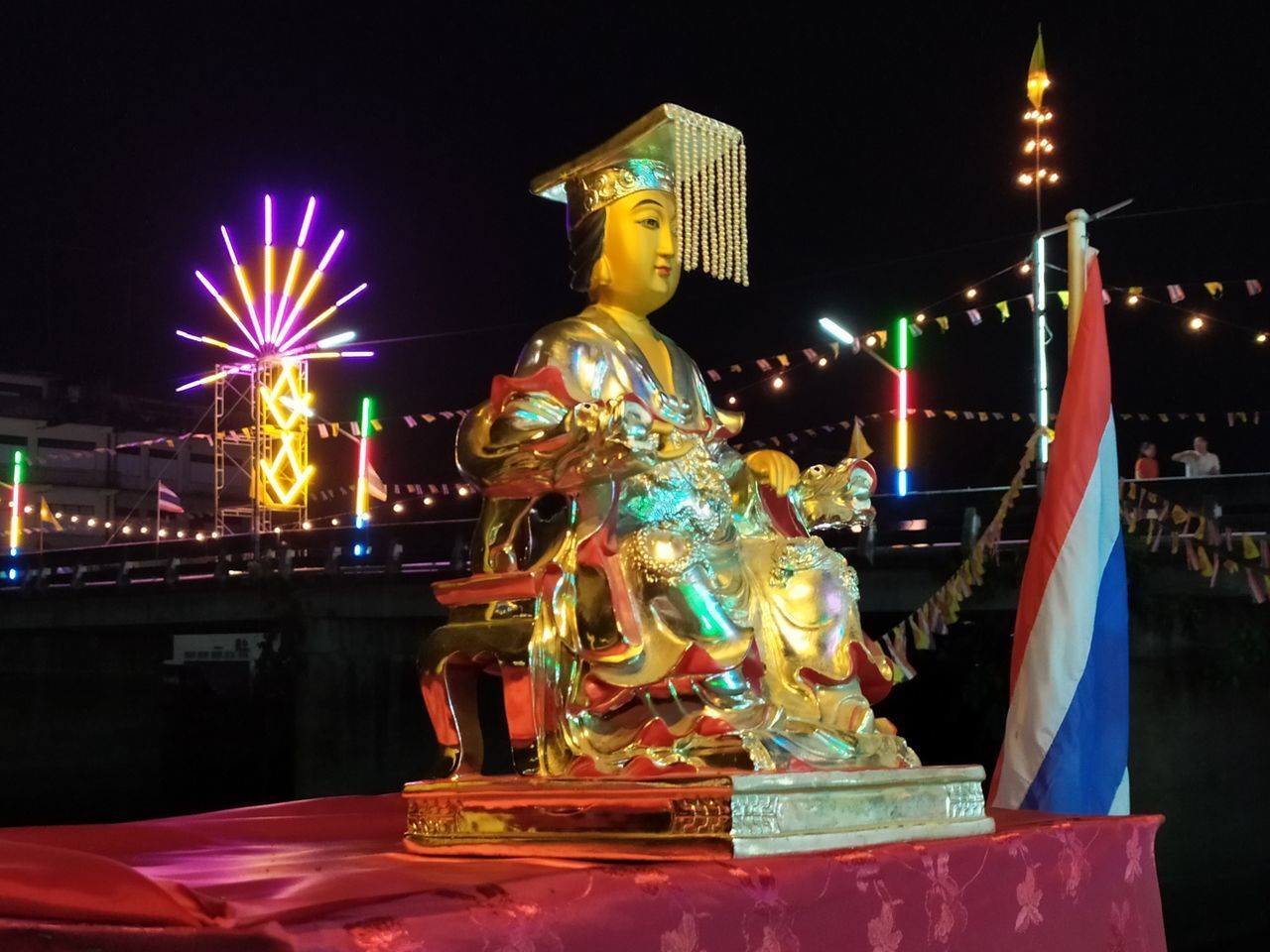 STATUE OF ILLUMINATED BUILDING AT NIGHT