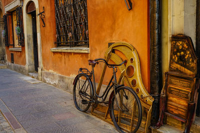 Bicycles parked against old building