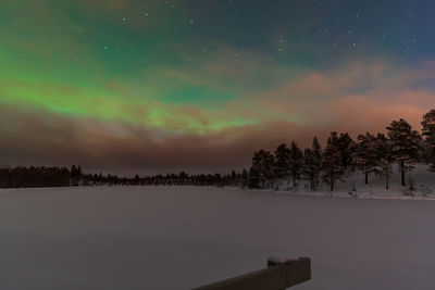 Scenic view of snow against sky at night