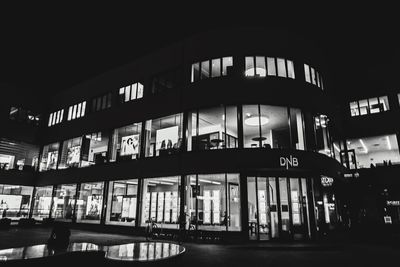 Low angle view of silhouette people in building