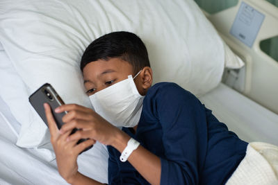 Man using mobile phone on bed