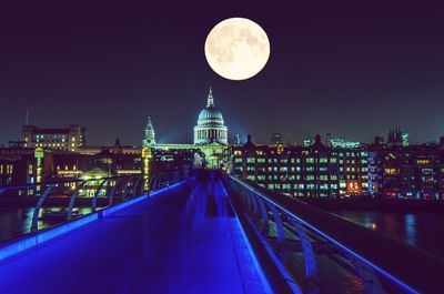 Illuminated city against sky at night