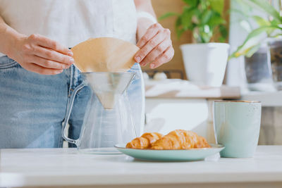 Midsection of woman preparing food on table