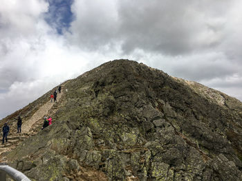 Low angle view of mountain against cloudy sky