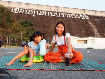 Portrait of a smiling boy sitting outdoors