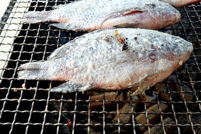 High angle view of fish on barbecue grill