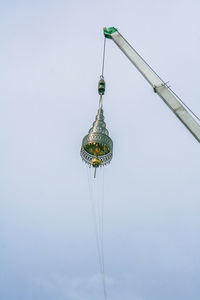 Close-up of hanging against sky