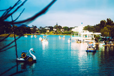 Sailboats in sea against sky