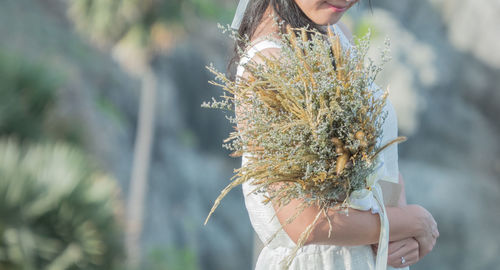 Close-up of woman holding flower