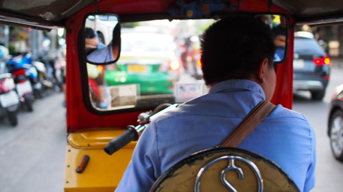 Rear view of man driving jinrikisha