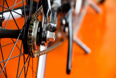 Close-up of bicycle over orange background