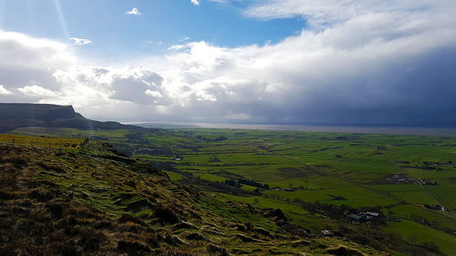 Scenic view of agricultural field against sky