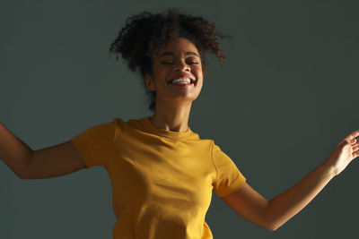 Smiling teenager girl against colored background