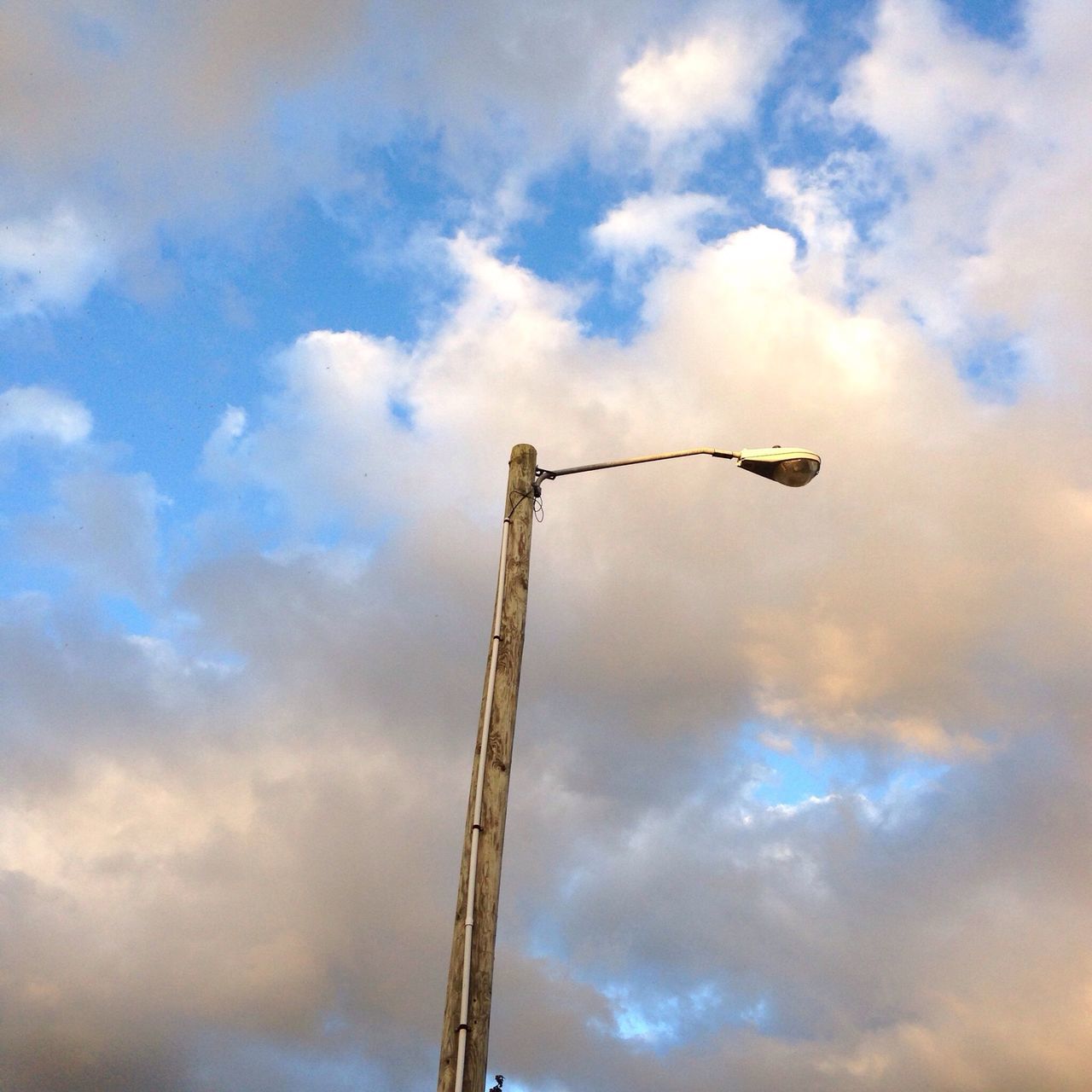 low angle view, sky, cloud - sky, cloudy, cloud, metal, weather, outdoors, overcast, no people, nature, pole, day, silhouette, street light, lighting equipment, dusk, crane - construction machinery, metallic, built structure