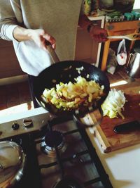 Midsection of man preparing food in kitchen