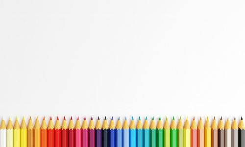 Close-up of colored pencils against white background