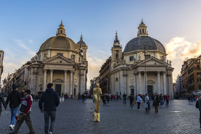 Group of people in front of buildings in city