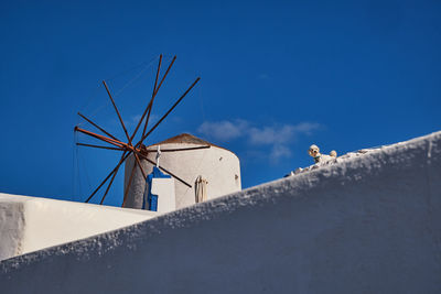 Low angle view of built structures against clear blue sky