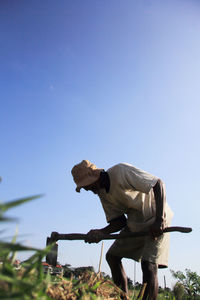 Man standing against clear blue sky