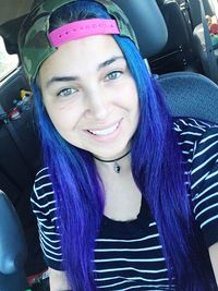 Portrait of smiling young woman in car