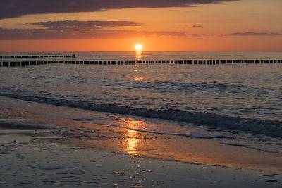 Scenic view of sea against orange sky