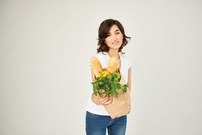 Portrait of a smiling young woman against white background