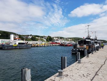 Pier over sea against sky in city