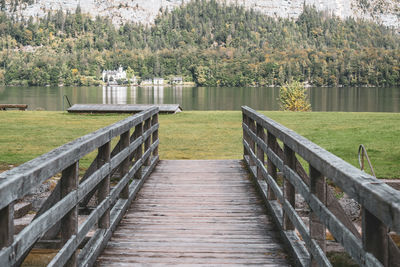 Wooden pier over lake with trees in background