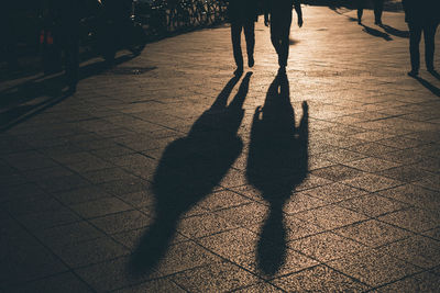 Low section of people walking on street