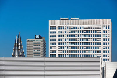 Low angle view of buildings against clear blue sky