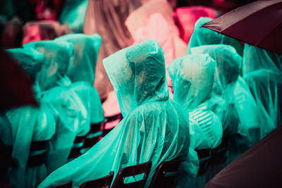 Fans wearing raincoat