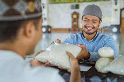 Man receiving rice from mosque