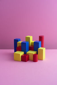 Close-up of toys on table against colored background