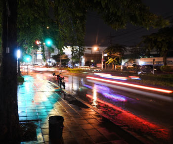 Light trails on city street during rainy season at night