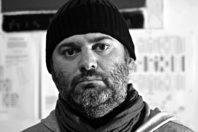 Close-up portrait of serious man wearing knit hat